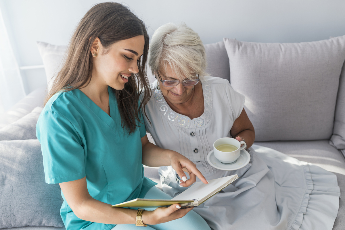 Caregiver Nurse planning with with senior.