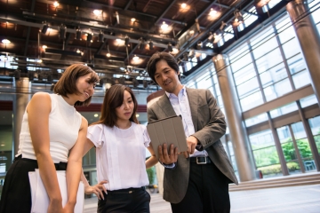 A business team viewing a tablet